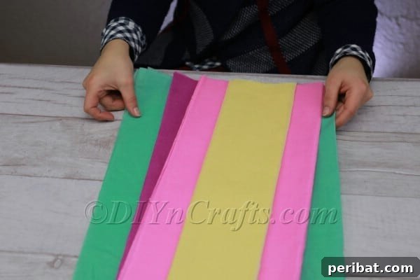 Stacked tissue paper strips in green, purple, pink, and yellow