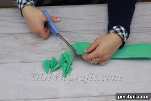 Green tissue paper cut into a leaf-like shape