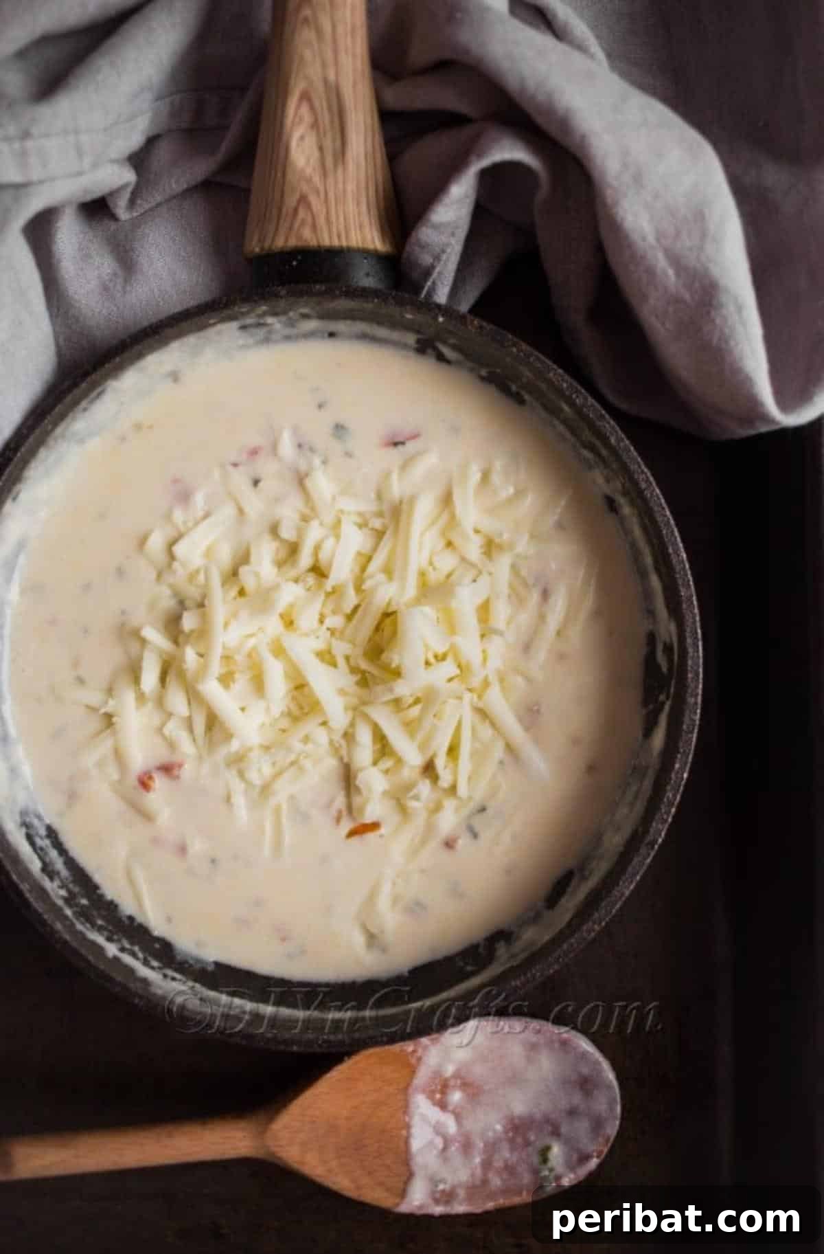 Score Big The Ultimate Game Day Queso 5 Adding cheese and cream to the queso dip mixture in a saucepan
