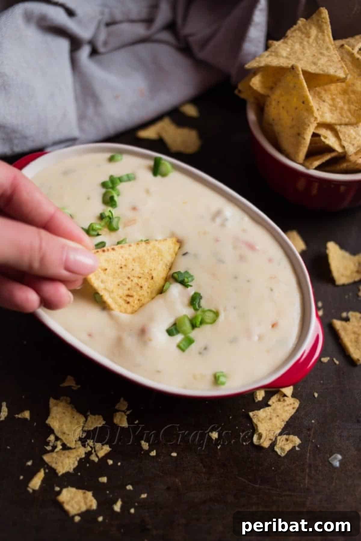 Score Big The Ultimate Game Day Queso 6 Finished queso dip served with tortilla chips and fresh vegetables