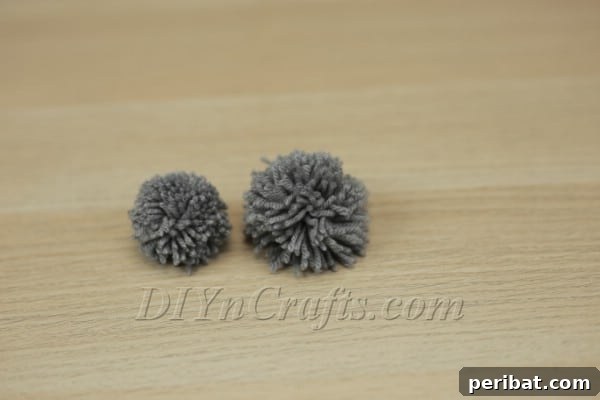 Two pom-poms of slightly different sizes for the bunny's head and body