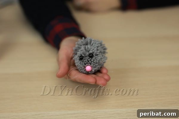 Gluing the nose with whiskers onto the bunny's face