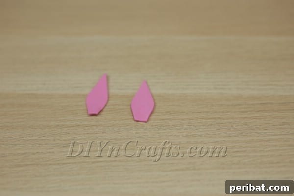 Two finished pink foam ear cutouts