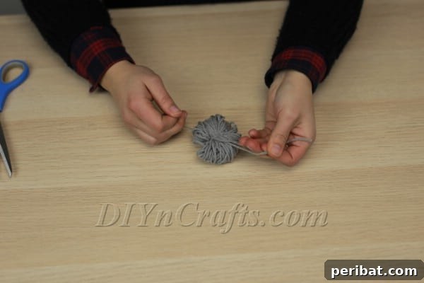 Yarn tied tightly around the center of spooled yarn
