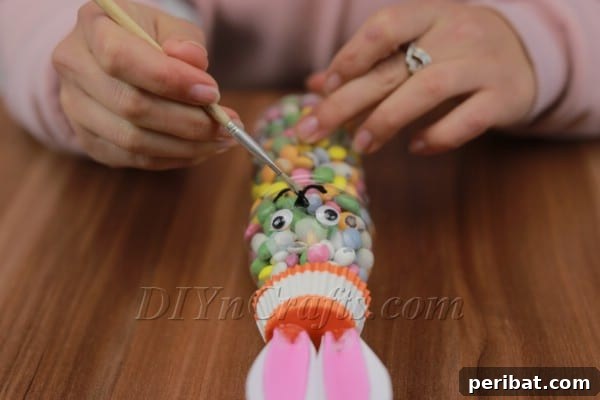 Drawing the bunny's nose and mouth with a black marker