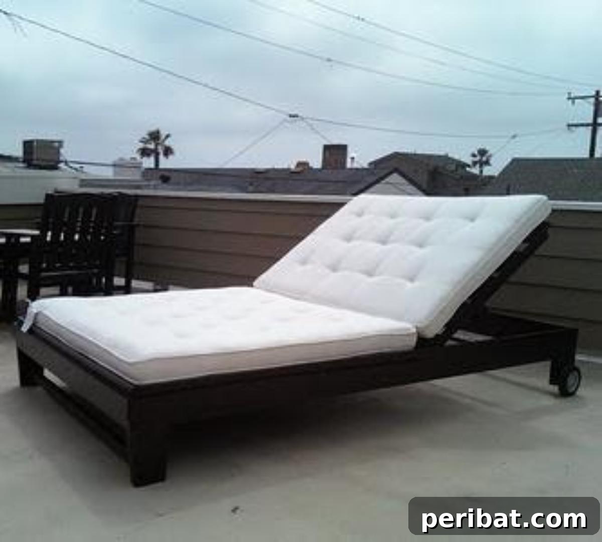 DIY Outdoor Oasis: 10 Projects for Beauty and Bliss 5 A stylish and comfortable DIY wooden chaise lounge with cushions in an outdoor setting.