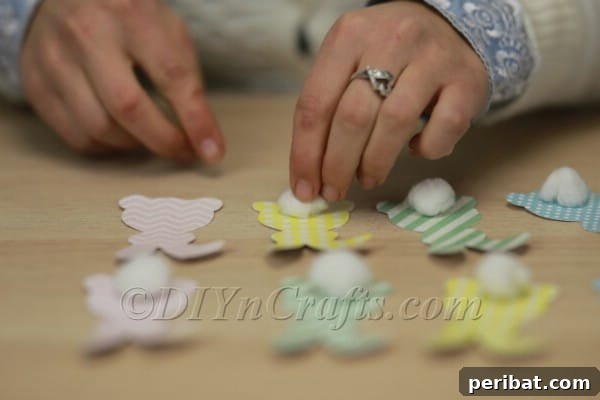 DIY Cute Paper Easter Bunny Garland with Free Printable Template 10 Close-up of bunny tail being glued