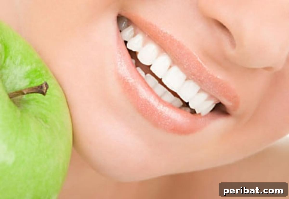 Smiling woman with healthy, moisturized lips, indicating lip care with castor oil