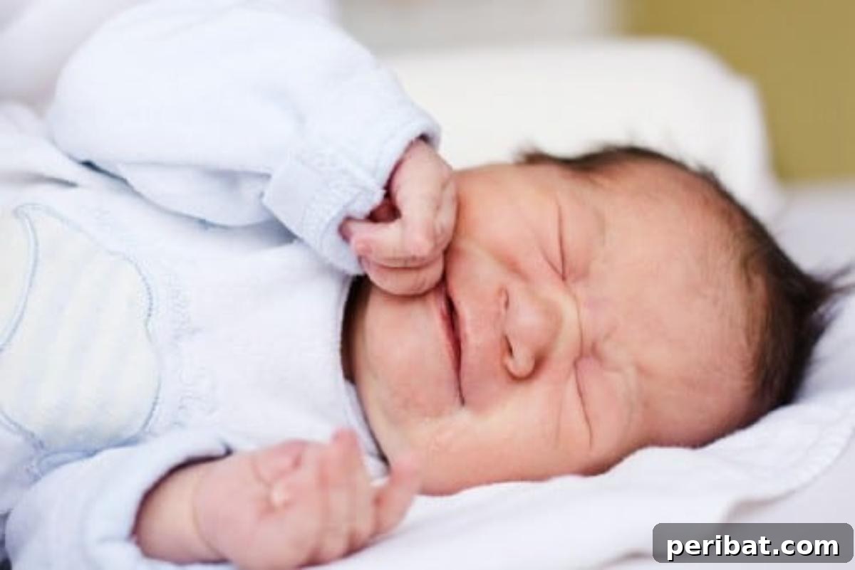 Baby sleeping peacefully, representing colic relief through gentle massage