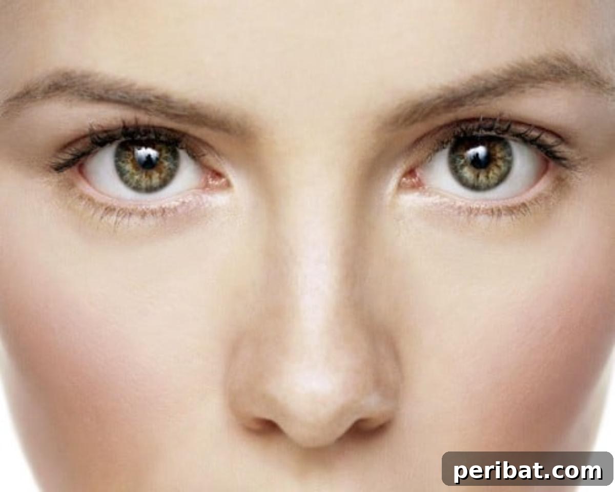 Woman's face with healthy, glowing skin, reflecting the benefits of castor oil