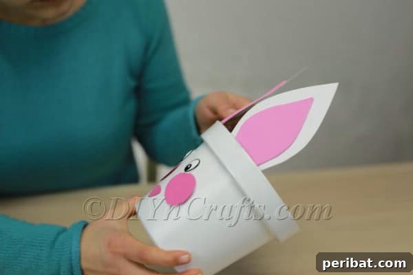 Attaching the bunny ears to the inside rim of the planter