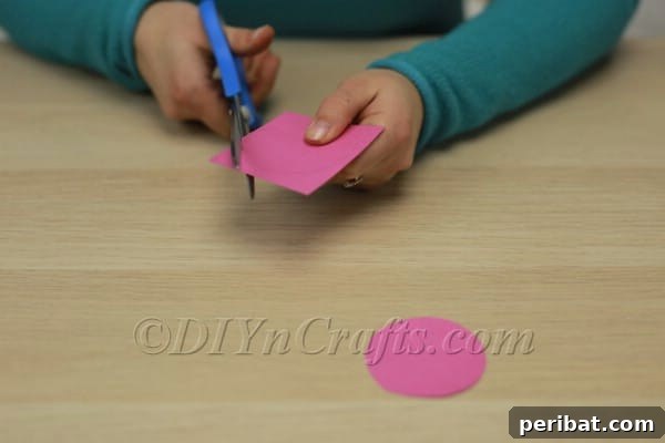 Cutting pink circles for cheeks and a triangle for the nose