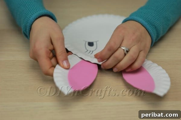 Bunny ears securely attached to the paper plate