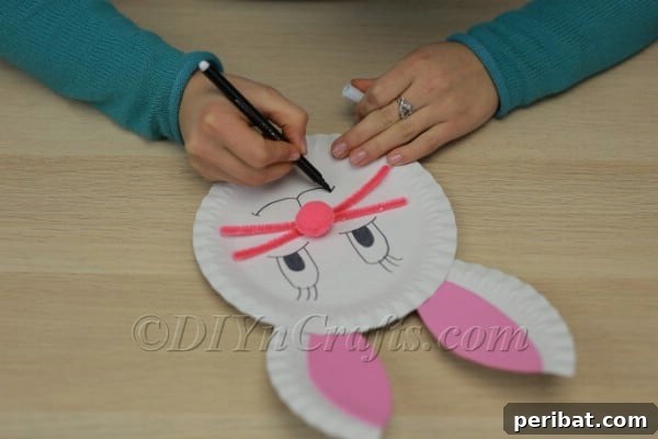 Three Adorable Easter Bunny Crafts Using Paper Plates 23 Drawing the bunny's mouth with a black marker