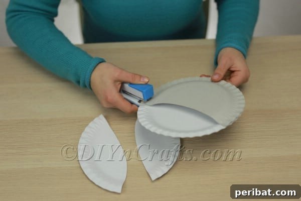 Three Adorable Easter Bunny Crafts Using Paper Plates 28 Stapling the pouch section to the main bunny face plate