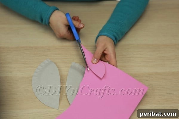 Three Adorable Easter Bunny Crafts Using Paper Plates 29 Cutting symmetrical bunny ears from the third paper plate