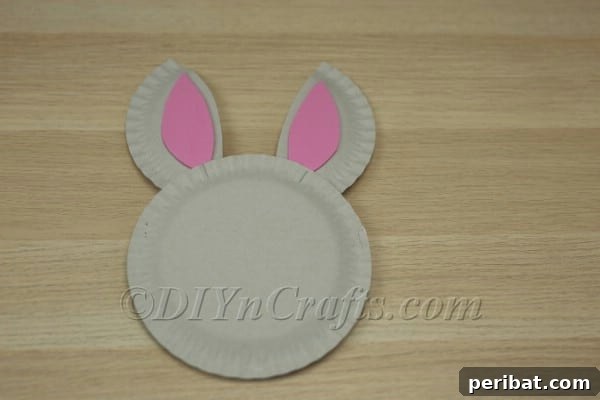 Three Adorable Easter Bunny Crafts Using Paper Plates 31 Gluing bunny ears to the back of the paper plate basket