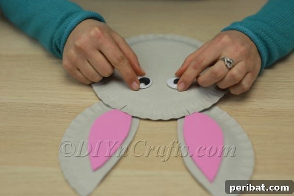 Three Adorable Easter Bunny Crafts Using Paper Plates 32 Attaching googly eyes to the paper plate bunny face