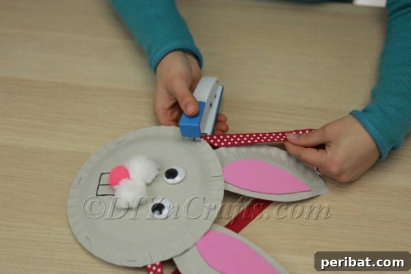 Three Adorable Easter Bunny Crafts Using Paper Plates 36 Stapling ribbon to the back for a basket handle