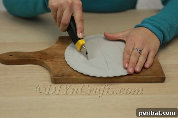 Three Adorable Easter Bunny Crafts Using Paper Plates 6 Cutting out the paper plate bunny ears