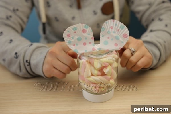 Craft an Adorable Easter Bunny Treat Holder from an Empty Nutella Container 11 Gluing the bunny's feet to the cap of the jar
