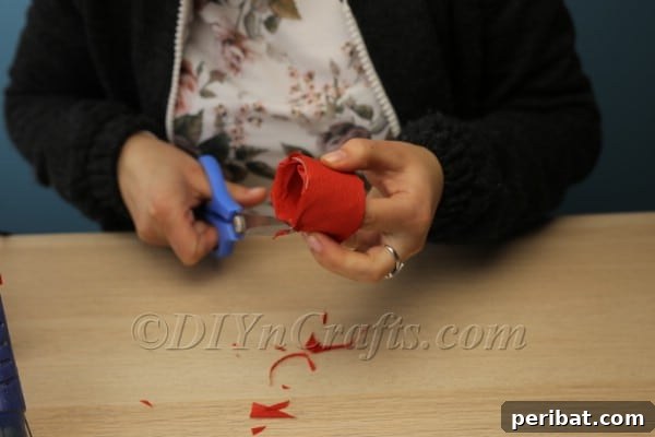 Blossoming Beauty: Craft Your Own Single Egg Easter Basket 14 Step 7: Securing the tissue paper inside the tube with glue.