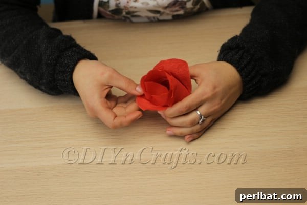 Blossoming Beauty: Craft Your Own Single Egg Easter Basket 16 Step 9: Gently fluffing out the tissue paper petals to create a flower shape.