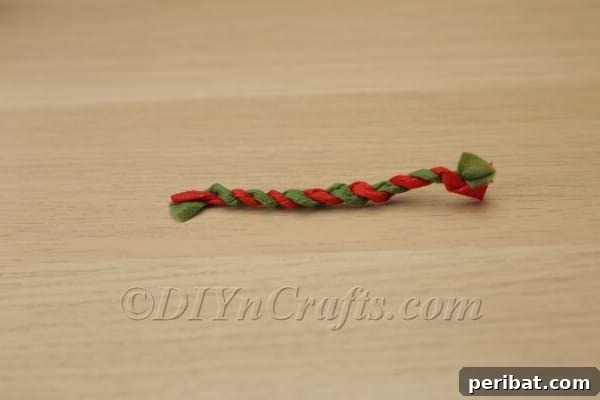 Blossoming Beauty: Craft Your Own Single Egg Easter Basket 23 Step 13: Twisting alternating colored tissue paper strips to create the handle.
