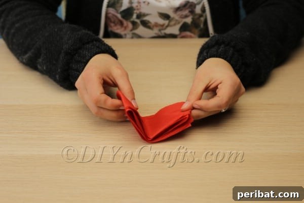 Blossoming Beauty: Craft Your Own Single Egg Easter Basket 10 Step 6: Unfolding the tissue paper to reveal a strip of connected petal shapes.