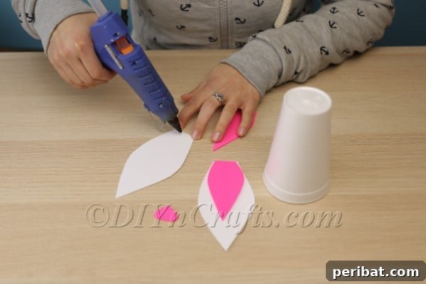 Gluing pink inner ears to white outer ears