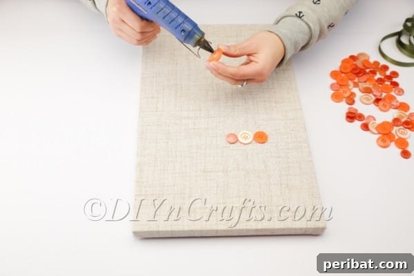 Whimsical Button Carrot Wall Art for Easter 6 Arranging buttons on the canvas for a balanced effect.