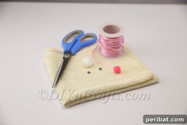 Lay the dish towel flat and fold diagonally to form a triangle.