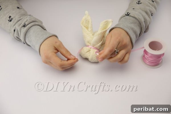Sweet Towel Bunnies: An Easy Easter DIY 10 Gluing googly eyes and a pom pom nose onto the towel bunny's face.