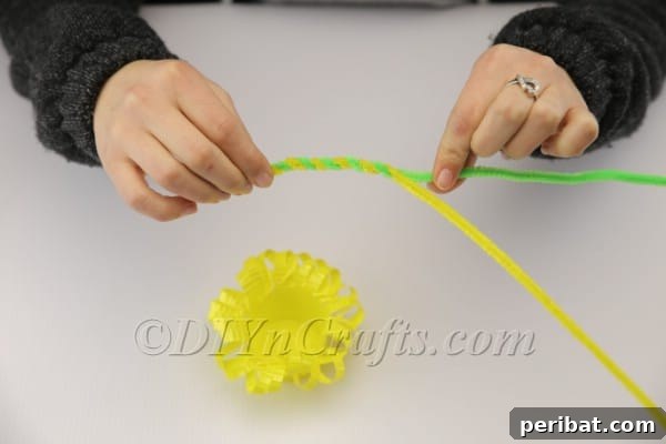 Twisting two pipe cleaners together for a basket handle