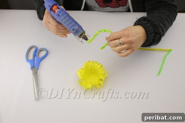 Transform a Plastic Cup into an Adorable Easter Basket 11 Applying hot glue to attach the pipe cleaner handle to the basket
