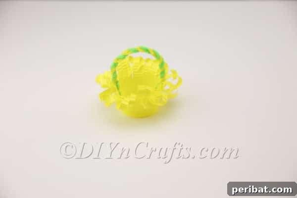 Securely attaching the pipe cleaner handle to the plastic cup basket