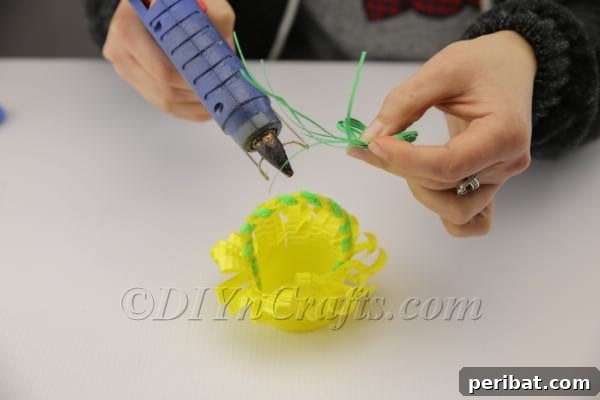 Decorating the plastic cup Easter basket with Easter grass and a ladybug