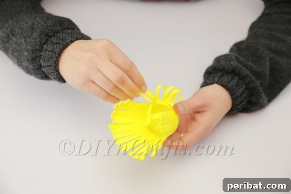 Transform a Plastic Cup into an Adorable Easter Basket 6 Bending down a plastic cup fringe to create a loop