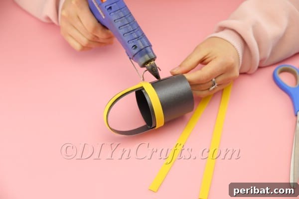 Foam Sheet Fun: Craft Your Own Easter Basket 11 Applying decorative yellow foam strips to the basket