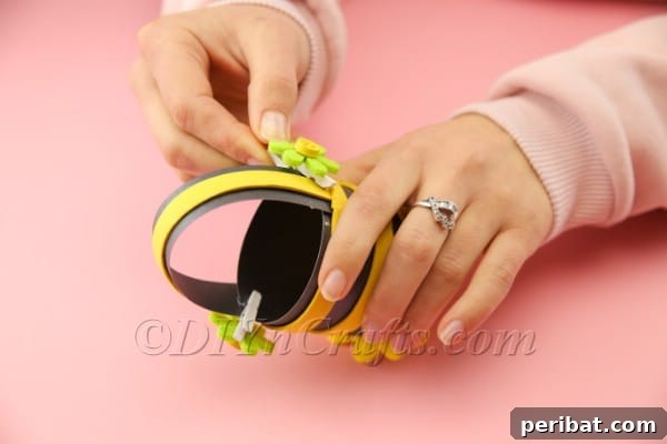 Adding decorative flowers to the Easter basket handle