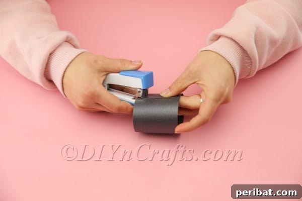 Stapling the foam strip to form a cylinder