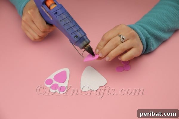 DIY Sweet Easter Bunny Treat Pouch Free Printable 18 Gluing pink paw pad to bunny paw