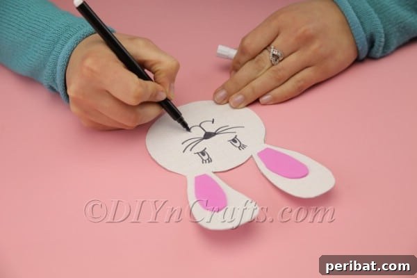 Drawing a bunny face with a black marker