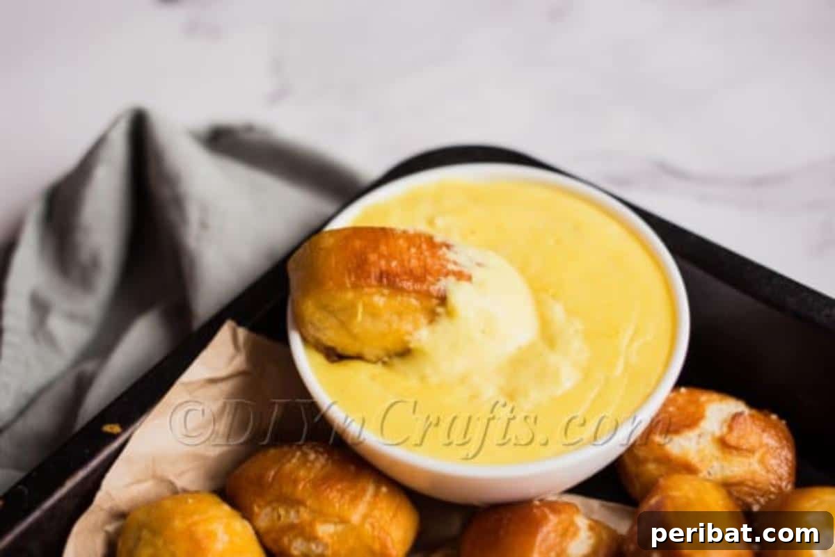 Homemade Soft Pretzel Bites with Warm Cheesy Dip 4 Yummy finished pretzel bites with cheese sauce
