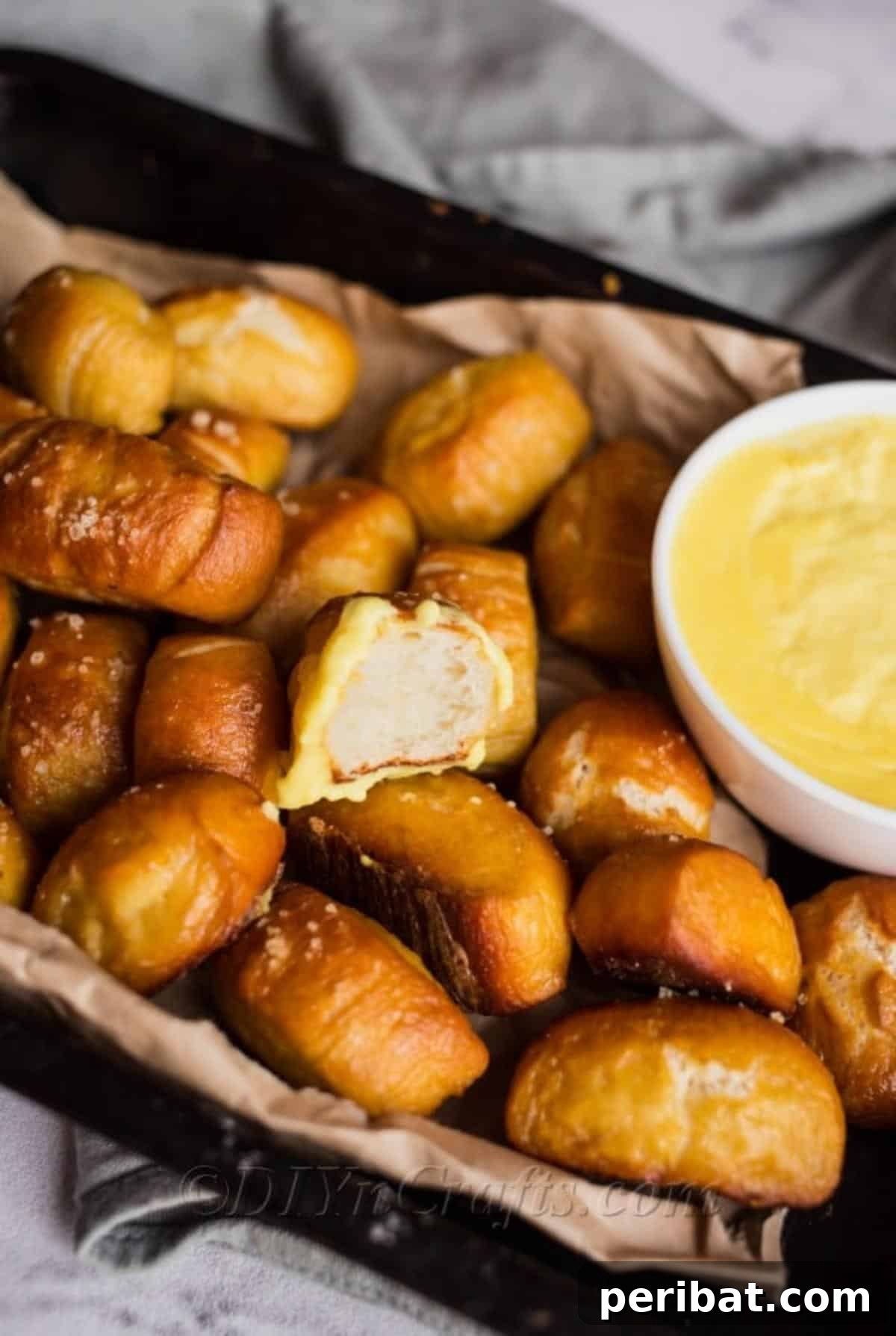 Homemade Soft Pretzel Bites with Warm Cheesy Dip 6 Soft pretzel cut in half, showing internal texture.