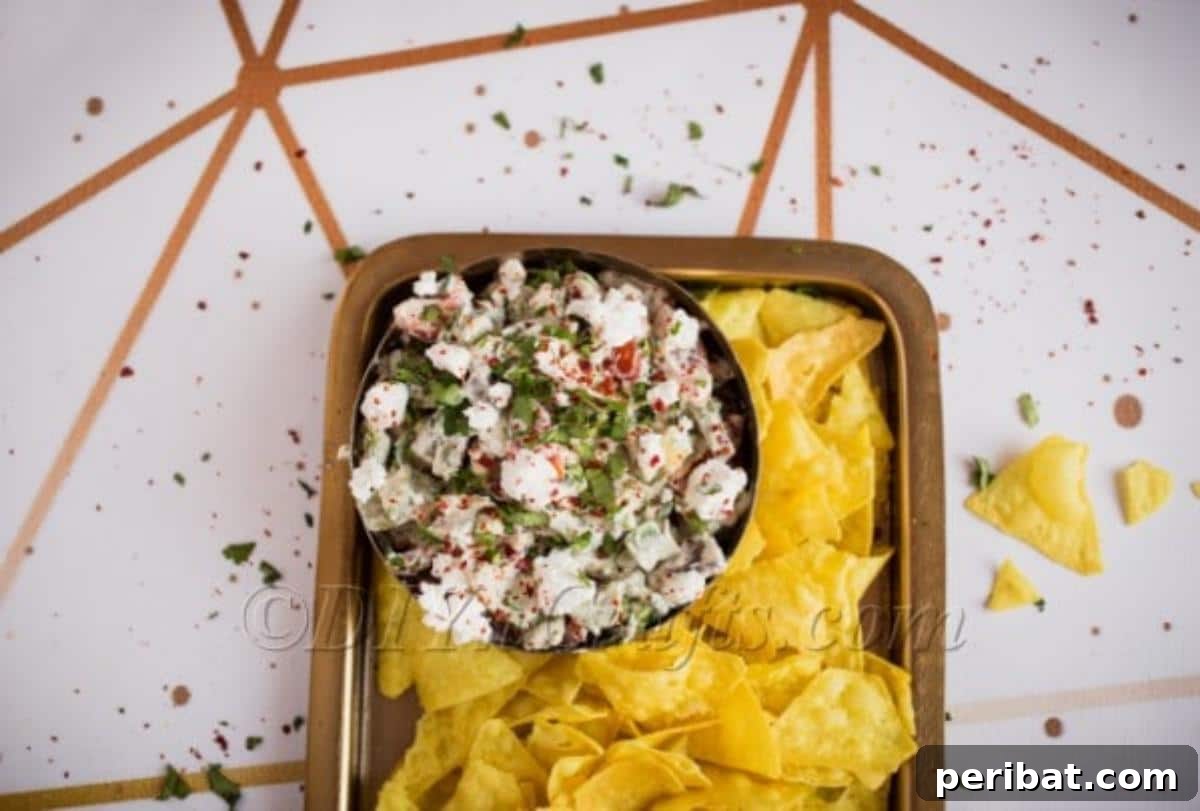 Mediterranean Avocado Feta Dip 5 Overhead shot of avocado dip with feta cheese served in a rustic bowl with tortilla chips.