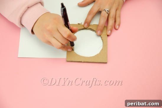 Cutting out paw shapes from white cardboard