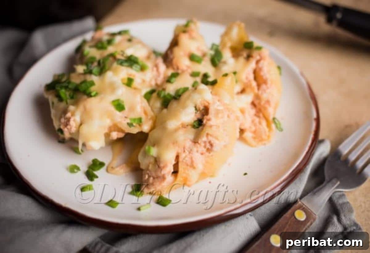 A serving of chicken stuffed pasta shells with cheese and sauce, plated and ready to eat.