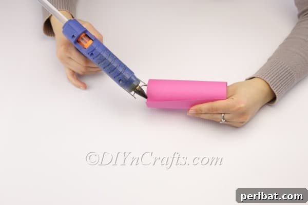 DIY Cute Paper Easter Bunny Candy Holder 6 Securing the paper tube with hot glue