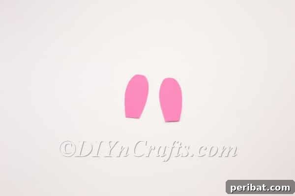 DIY Cute Paper Easter Bunny Candy Holder 7 Cutting the outer bunny ears from pink construction paper